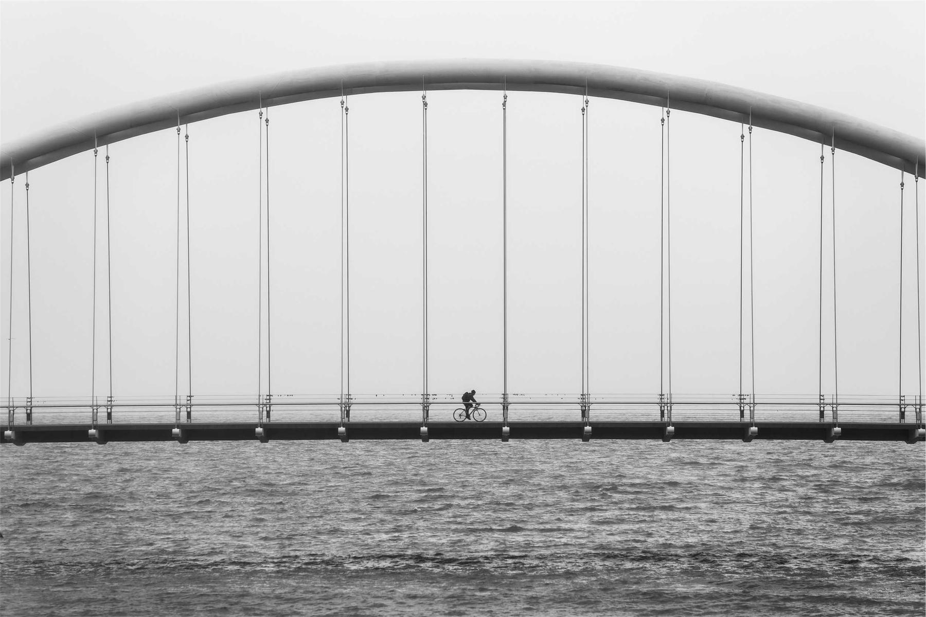 An arched bridge over grey water