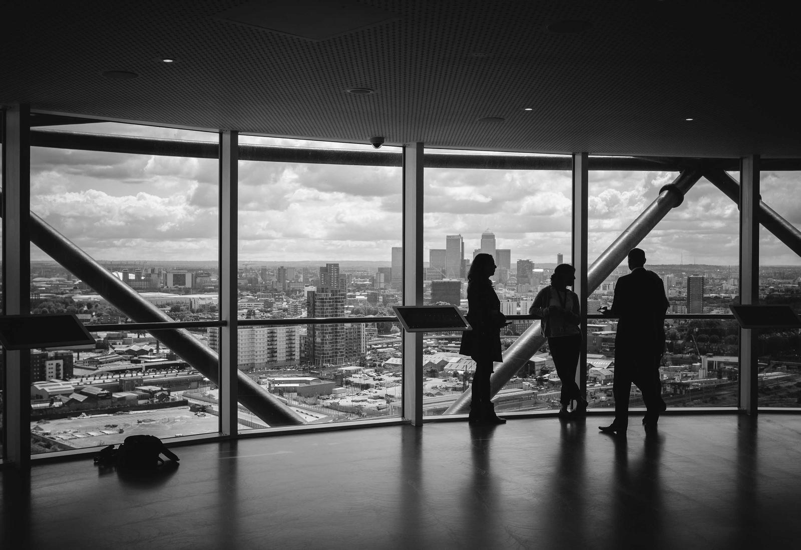 Colleagues talking by the windows of a high-rise office